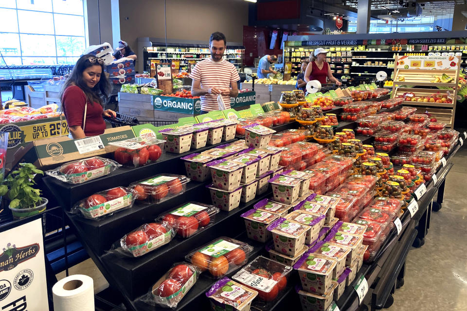 Shoppers shop at a grocery store in Glenview, Ill., Monday, July 4, 2022. U.S. demand for grocery delivery is cooling as food prices rise. Some shoppers are shifting to less expensive grocery pickup, while others are returning to the store. (AP Photo/Nam Y. Huh)