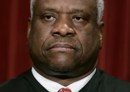 U.S. Associate Justice Clarence Thomas poses for an official picture with other justices at the U.S. Supreme Court in Washington, in this file photo taken October 31, 2005. REUTERS/Jason Reed/Files