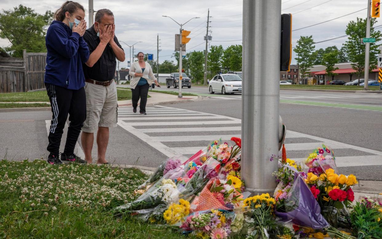 People pay their respects - Brett Gundlock/The Canadian Press via AP