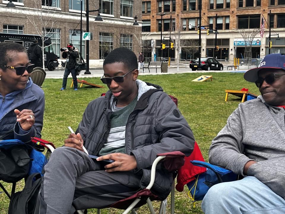 Maze Pelham of Baltimore, a high school senior, planned his family’s trip Monday to Rochester to view the April 8, 2024, total solar eclipse at Parcel 5. Here, he talks with mother Janice Pelham and father Sonney Pelham.