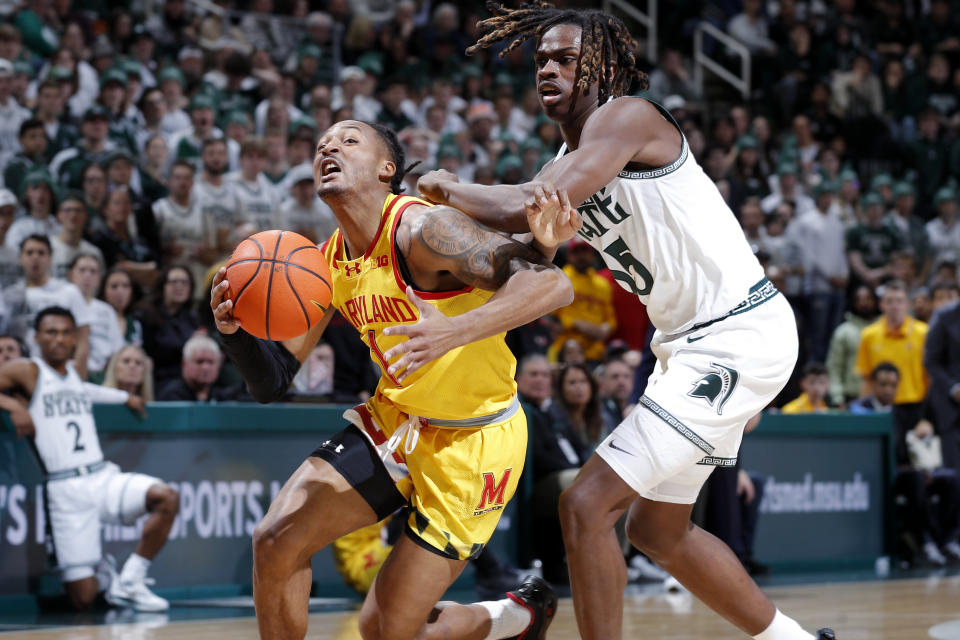 Maryland guard Jahmir Young, left, drives against Michigan State forward Coen Carr, right, during the first half of an NCAA college basketball game, Saturday, Feb. 3, 2024, in East Lansing, Mich. (AP Photo/Al Goldis)