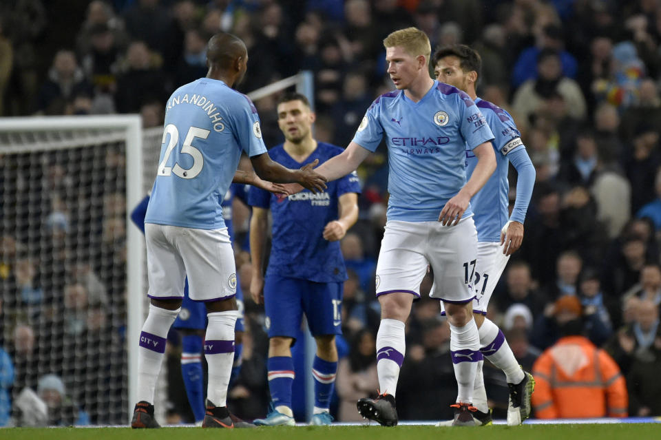 Manchester City's Kevin De Bruyne celebrates with Fernandinho, left, after scoring his side's first goal during the English Premier League soccer match between Manchester City and Chelsea at Etihad stadium in Manchester, England, Saturday, Nov. 23, 2019. (AP Photo/Rui Vieira)