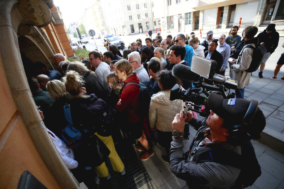 People gather outside the district court in Stockholm, Thursday Aug. 1, 2019. American rapper A$AP Rocky pleaded not guilty to assault as his trial in Sweden opened Tuesday, a month after a street fight that landed him in jail and became a topic of U.S.-Swedish diplomacy. (Fredrik Persson/TT News Agency via AP)