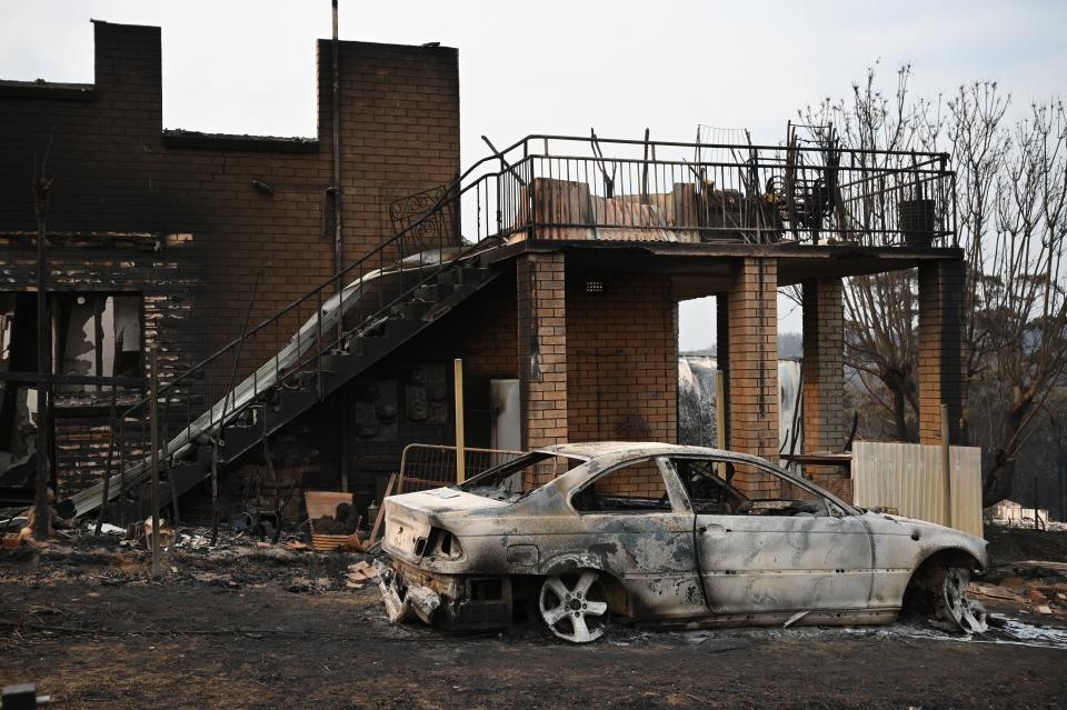 A house and vehicle gutted by bushfires are seen in the town of Lake Conjola in New South Wales on January 1, 2020. - A major operation to reach thousands of people stranded in fire-ravaged seaside towns was under way in Australia on January 1 after deadly bushfires ripped through popular tourist spots and rural areas leaving at least eight people dead. (Photo by PETER PARKS / AFP) (Photo by PETER PARKS/AFP via Getty Images)