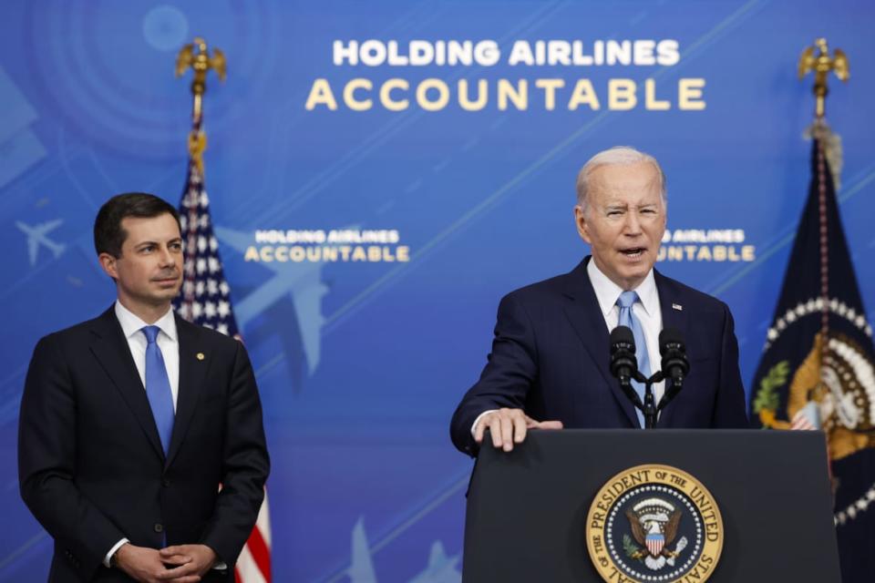 U.S. President Joe Biden speaks as Transportation Secretary Pete Buttigieg looks on at an announcement of new airline regulations in the South Court Auditorium on the White House campus on May 8, 2023, in Washington, D.C. (Photo by Anna Moneymaker/Getty Images)
