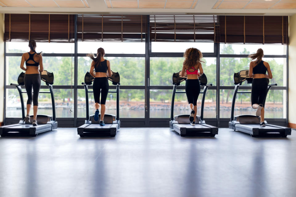 Rear view of women running on treadmill
