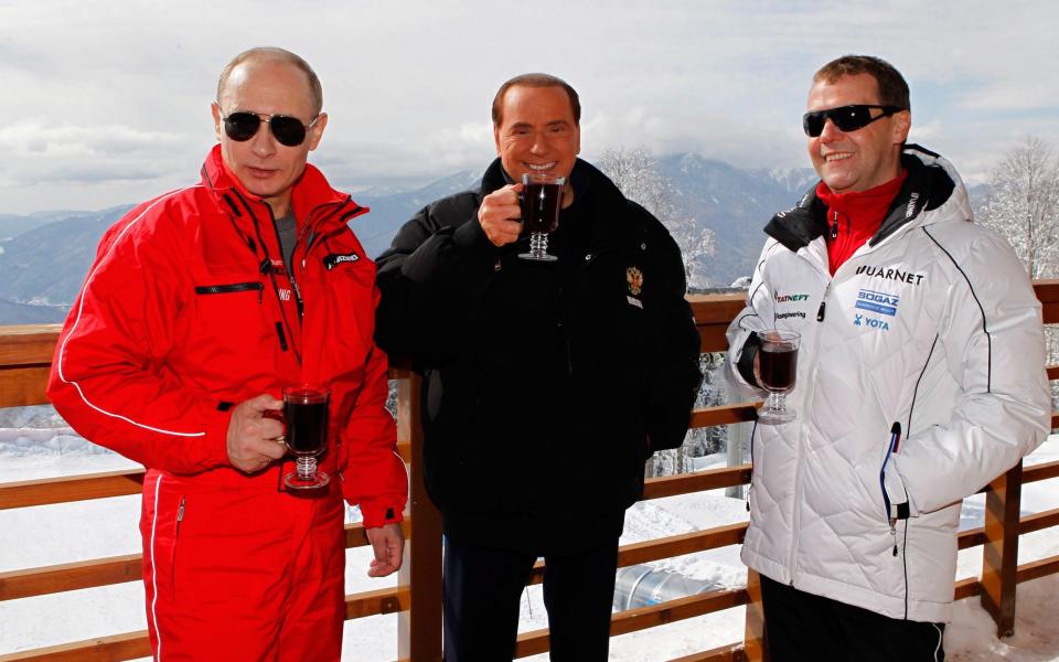 Berlusconi, centre, in 2012 enjoying a break with Putin and Dmitry Medvedev, the Russian president in Sochi, Russia