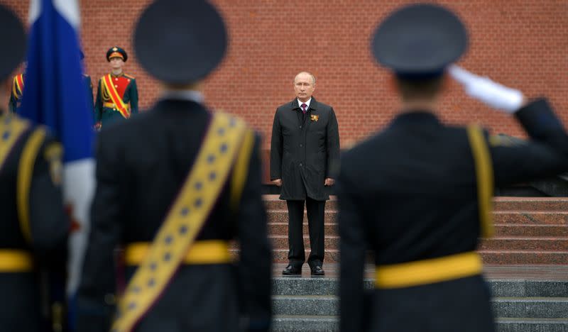 Russian President Vladimir Putin takes part in a flower-laying ceremony at the Tomb of the Unknown Soldier on Victory Day in central Moscow