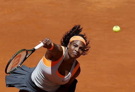 Serena Williams of the U.S. serves the ball to Carla Suarez Navarro of Spain during their match at the Madrid Open tennis tournament in Madrid, Spain, May 7, 2015. REUTERS/Andrea Comas