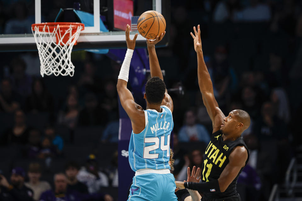 Charlotte Hornets forward Brandon Miller (24) shoots against Utah Jazz guard Kris Dunn during the first half of an NBA basketball game in Charlotte, N.C., Saturday, Jan. 27, 2024. (AP Photo/Nell Redmond)