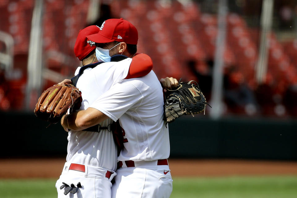 St. Louis Cardinals' Yadier Molina, left, celebrates with Adam Wainwright after Wainwright pitched nine complete innings against the Cleveland Indians, Sunday, Aug. 30, 2020, in St. Louis. (AP Photo/Scott Kane)