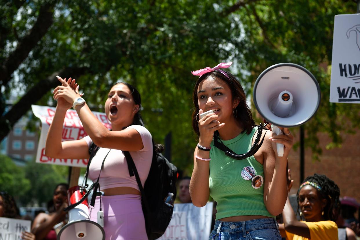 FILE - Protest organizers River Good (left) and Elleana Garcia speak to the crowd during the Women's Rights March down Broad Street on Saturday, July 2, 2022. Garcia was recently named the new Miss Augusta.