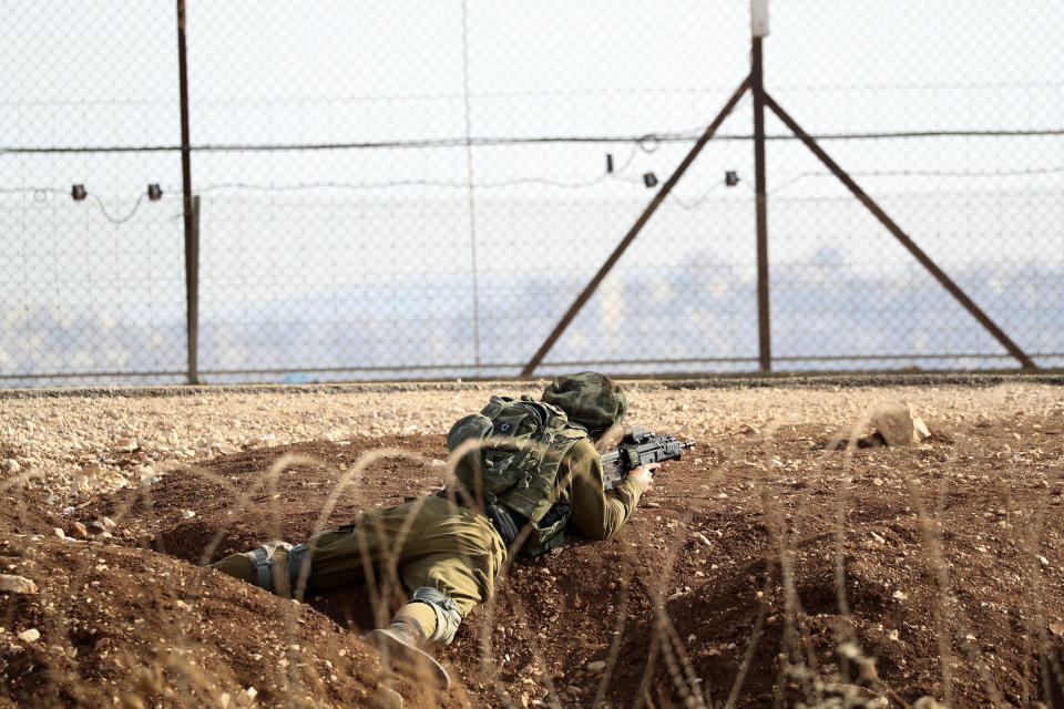 An Israeli soldier takes position along the border between the northern West Bank near Jenin and Israel as they search for two Palestinians who broke out of a maximum-security prison last week, on a road leading to the West Bank town of Jenin, near Gan Ner Israel, Sunday, Sept. 12, 2021. Israeli police on Saturday said they arrested four of the six Palestinians who broke out of the prison including Zakaria Zubeidi a famed militant leader whose exploits over the years have made him a well-known figure in Israel. (AP Photo/Ariel Schalit)