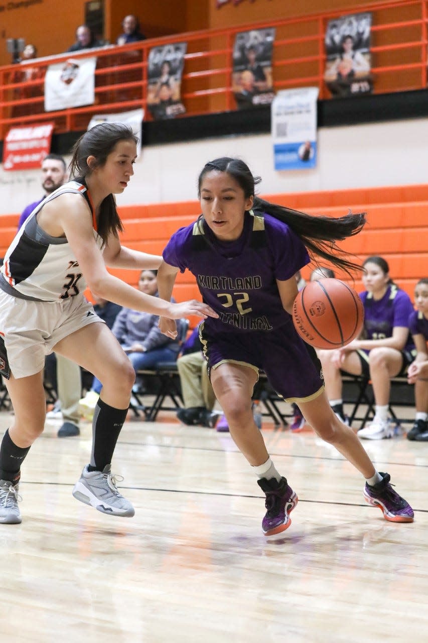 Kirtland Central's Teghan Begay drives by Aztec's Jazzlyn Gomez on the baseline in the third quarter on Thursday, February 9, 2023 at Lillywhite Gym.