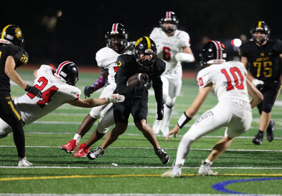 McQuaid's John Harding heads through an opening before being brought down by Penfield's Brodie Joyce and Adam Schembri.