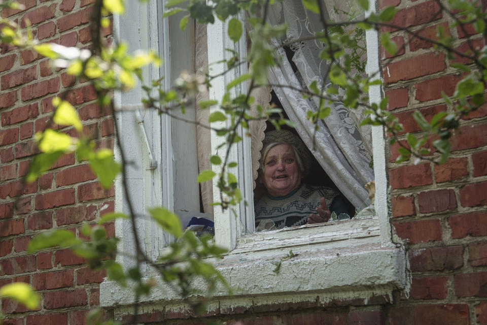 Valentyna reacts before leaving her home during evacuation to Kharkiv, in Vovchansk, Ukraine, on Saturday, May 11, 2024. (AP Photo/Evgeniy Maloletka)