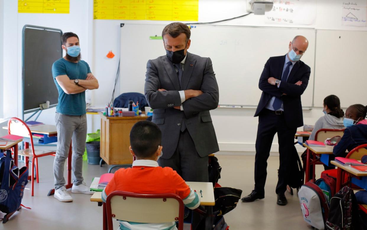 French President Emmanuel Macron talks with a pupil while visiting a school in Melun, south of Paris - Thibault Camus /AP