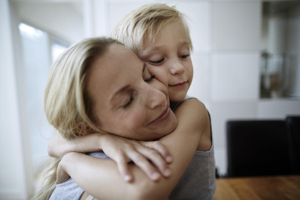 Woman hugging child (Getty Images)