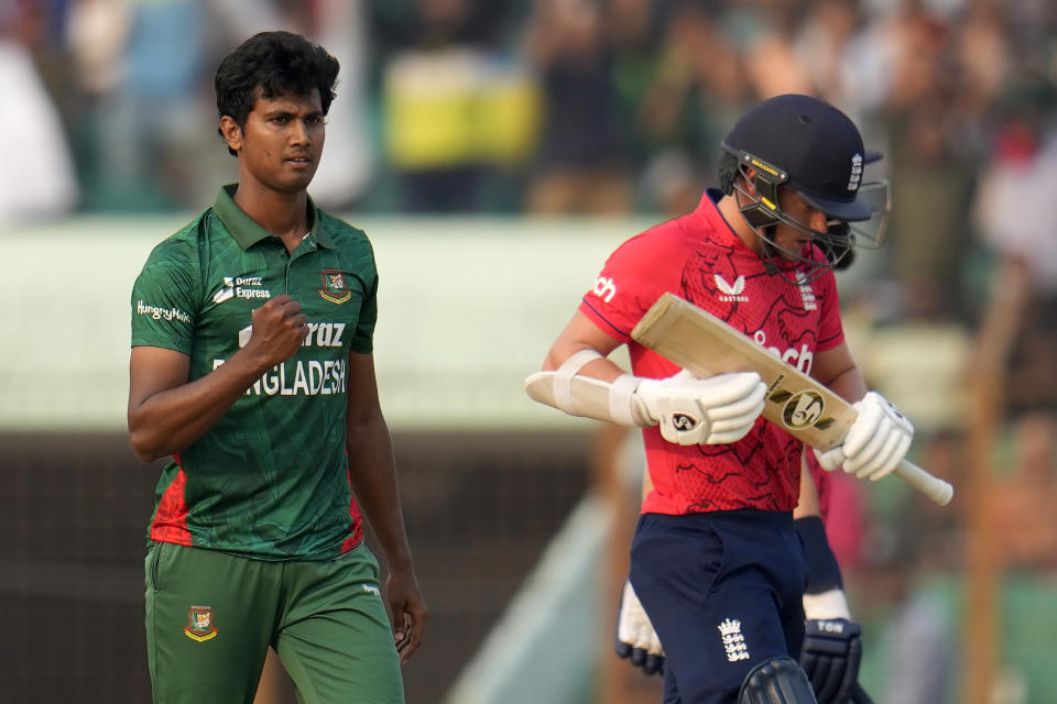 Bangladesh's Hasan Mahmud, left, celebrates the dismissal of England's Sam Curran, right, during the first T20 cricket match between Bangladesh and England in Chattogram, Bangladesh, Thursday, March 9, 2023. (AP Photo/Aijaz Rahi)