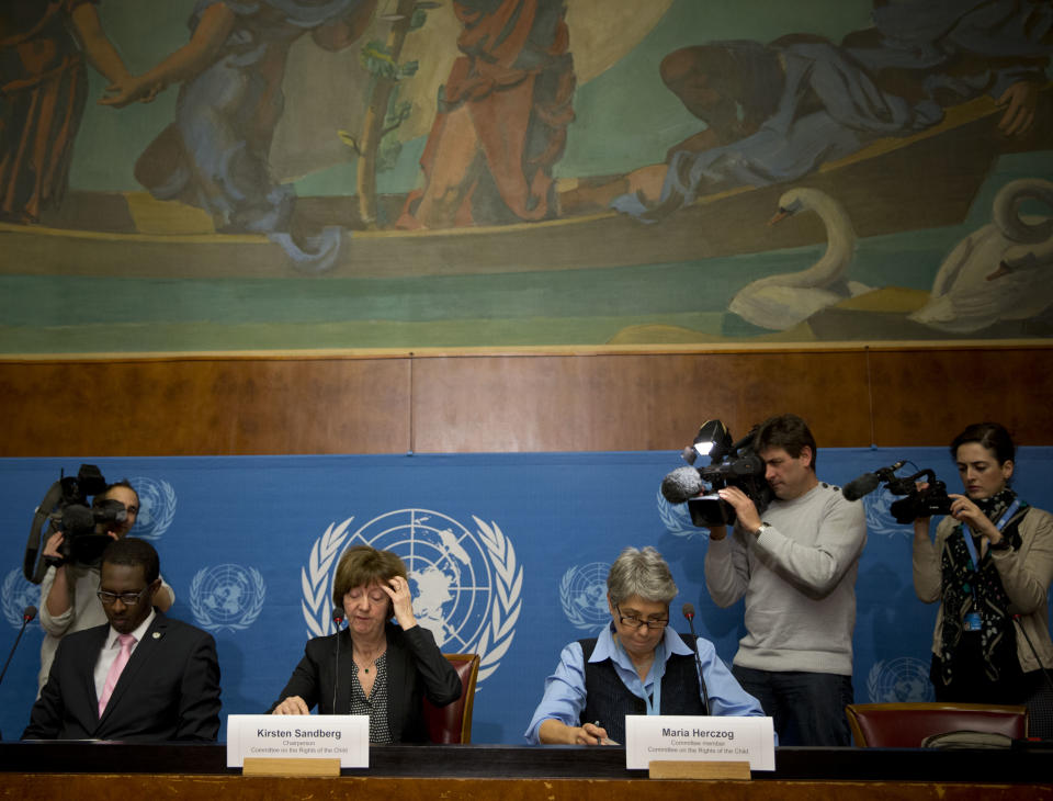 Kirsten Sandberg, center, chairperson of the U.N. human rights committee on the rights of the child, gestures as she joins committee members Maria Herczog, right, and Benyam Mezmur, left, for a press conference at the United Nations headquarters in Geneva, Switzerland, Wednesday, Feb. 5, 2014. A U.N. human rights committee denounced the Vatican on Wednesday for adopting policies that allowed priests to rape and molest tens of thousands of children over decades, and urged it to open its files on the pedophiles and the churchmen who concealed their crimes. (AP Photo/Anja Niedringhaus)