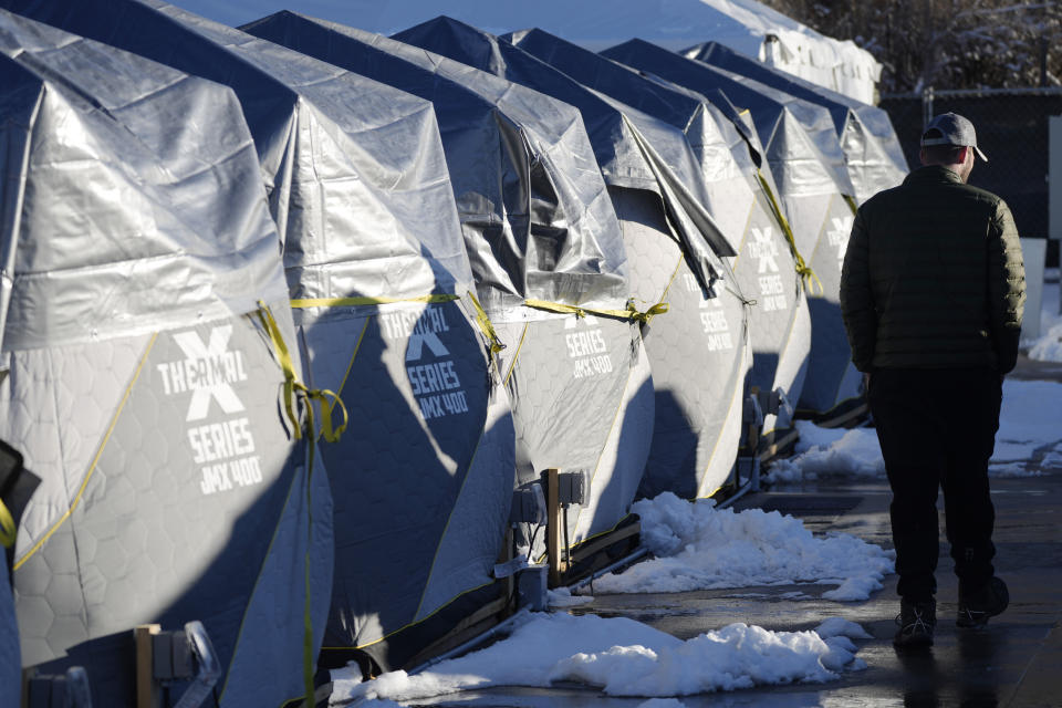 Tents stand in a long row at the east safe outdoor space in the parking lot of the city of Denver Human Service building in Denver on Thursday, Feb. 17, 2022. The safe space is home to more than 150 people. (AP Photo/David Zalubowski)