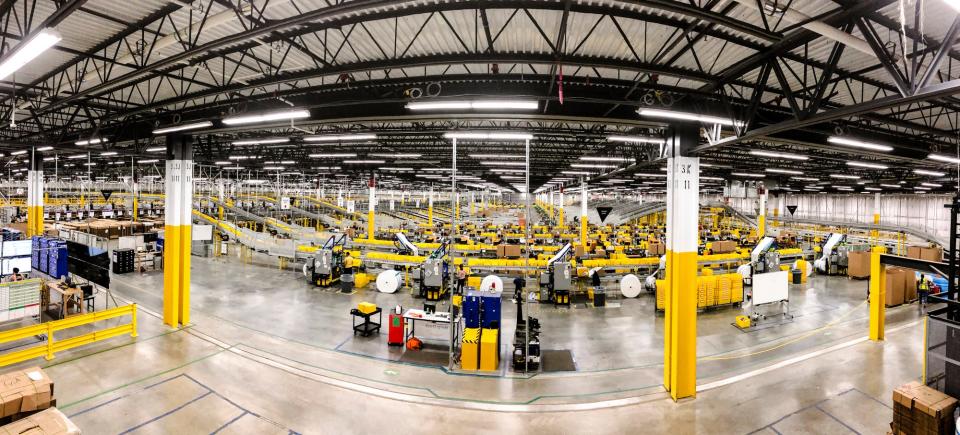 Employees work inside an Amazon Fulfillment Center.