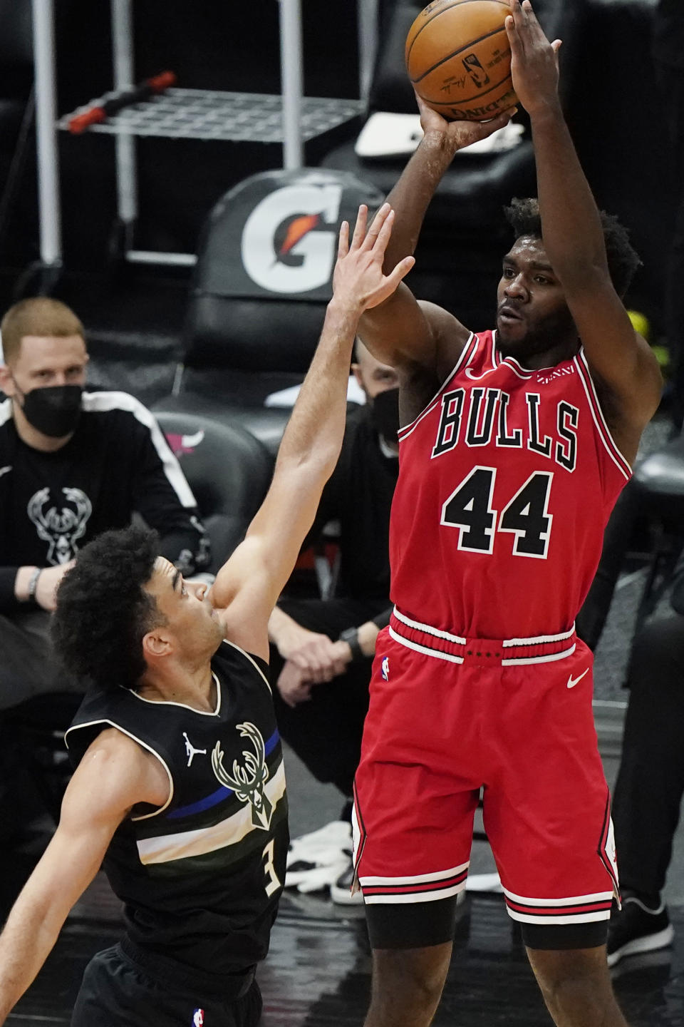 Chicago Bulls forward Patrick Williams, right, shoots over Milwaukee Bucks guard Elijah Bryant during the first half of an NBA basketball game in Chicago, Sunday, May 16, 2021. (AP Photo/Nam Y. Huh)