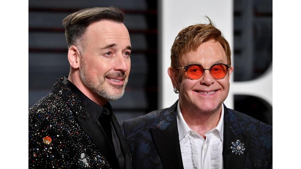 David Furnish and Sir Elton John on red carpet 