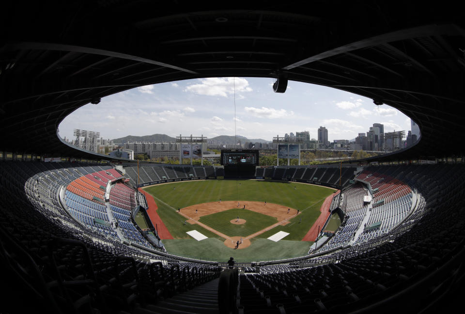 Stadium seats are empty as a part of precaution against the new coronavirus during the pre-season baseball game between Doosan Bears and LG Twins in Seoul, South Korea, Tuesday, April 21, 2020. South Korea's professional baseball league has decided to begin its new season on May 5, initially without fans, following a postponement over the coronavirus. (AP Photo/Lee Jin-man)