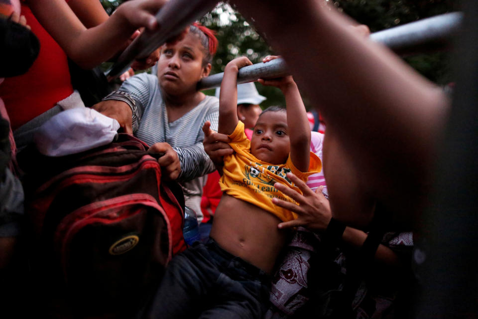 <p>People belonging to a caravan of migrants from El Salvador en route to the United States board a pickup truck to hitchhike along the highway to Ciudad Tecun Uman, Guatemala from Moyuta, Guatemala, Nov. 1, 2018. (Photo: Jose Cabezas/Reuters) </p>