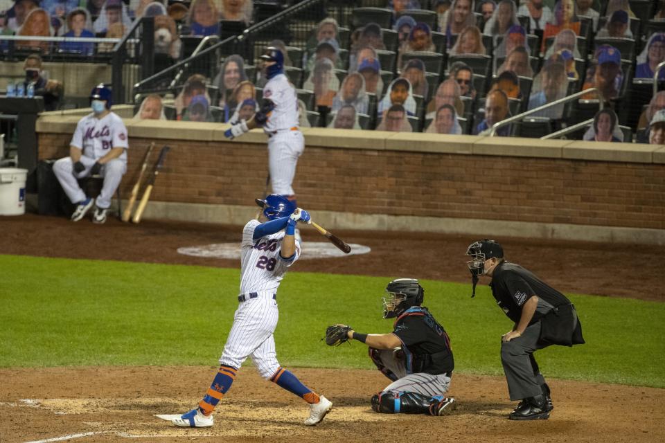 New York Mets' J.D. Davis (28) follows through on a three-run home run during the seventh inning of a baseball game against the Miami Marlins Saturday, Aug. 8, 2020, in New York. (AP Photo/Frank Franklin II)