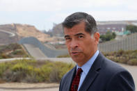 Attorney General of California Xavier Becerra walks along the U.S.-Mexico border at the Pacific Ocean after announcing a lawsuit against the Trump Administration over its plans to begin construction of border wall in San Diego and Imperial Counties, in San Diego, California, U.S., September 20, 2017. REUTERS/Mike Blake