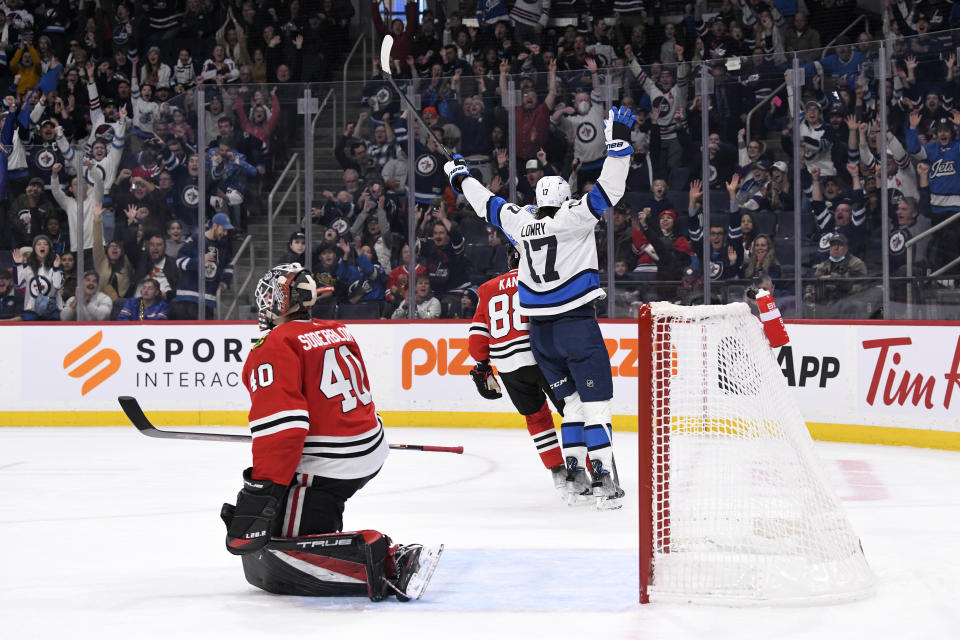 Winnipeg Jets' Adam Lowry (17) celebrates his goal against Chicago Blackhawks goaltender Arvid Soberblom (40) during the second period of NHL hockey game action in Winnipeg, Manitoba, Saturday, Nov. 5, 2022. (Fred Greenslade/The Canadian Press via AP)