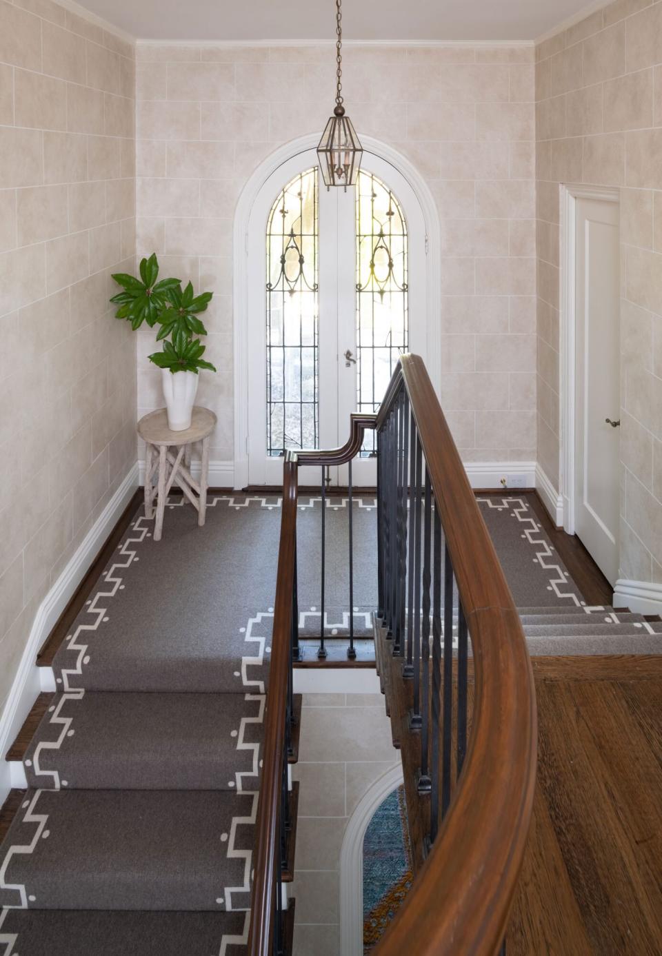 Elegant Staircase with French Doors and Stair Runner