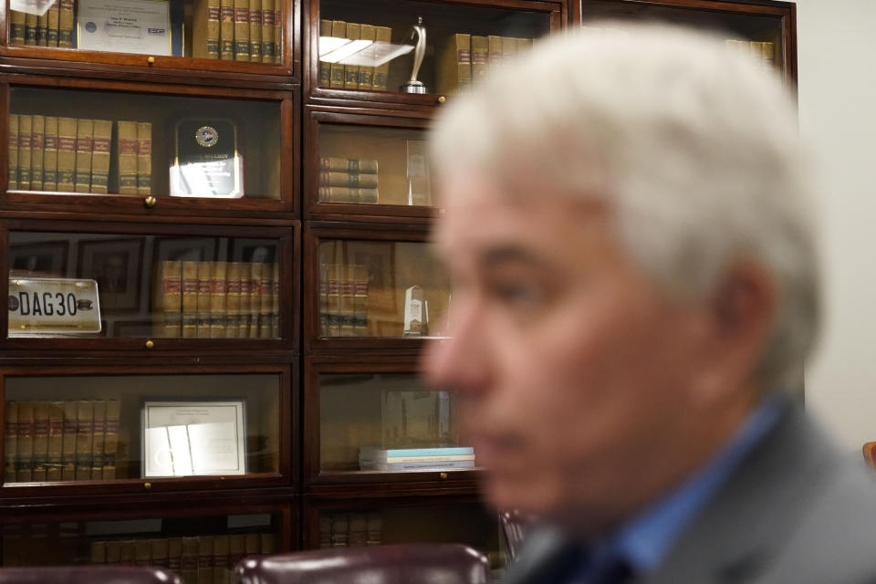 Law books sit in a bookcase as district attorney Steve Mulroy speaks during an interview with the Associated Press, in response to the investigation of the death of Tyre Nichols, who died after being beaten by Memphis police officers, in Memphis, Tenn., Tuesday, Jan. 24, 2023. Two Memphis Fire Department employees have been removed from duty while the agency conducts an investigation into the death of Nichols, a Black man, after a violent arrest that led to the firing of five police officers. (AP Photo/Gerald Herbert)