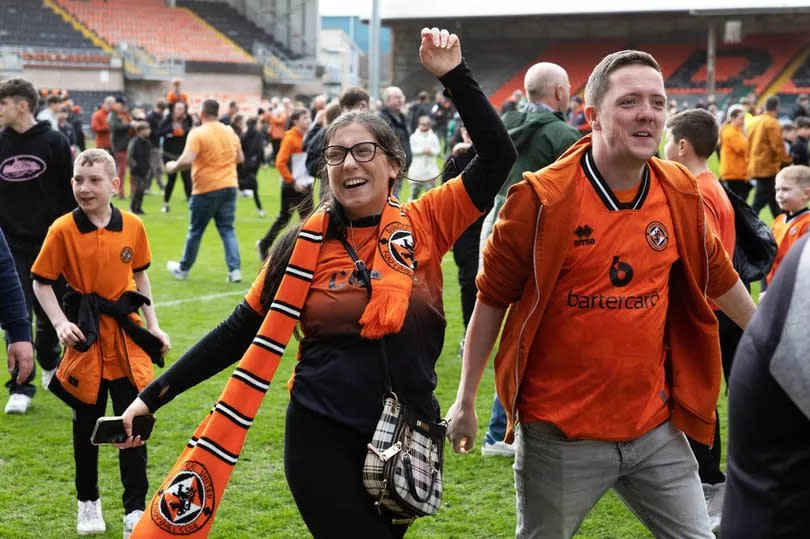 Dundee United fans on the pitch at full time -Credit:SNS Group