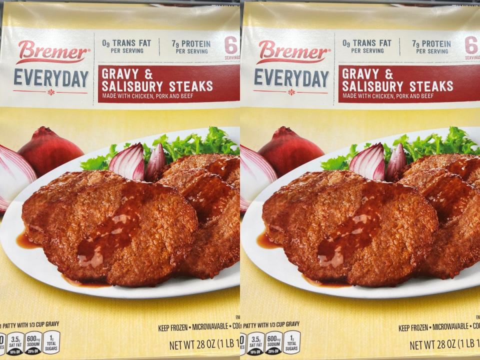 A yellow box of Bremer Everyday gravy and Salisbury steaks with an image of steaks with red onion and lettuce on the box