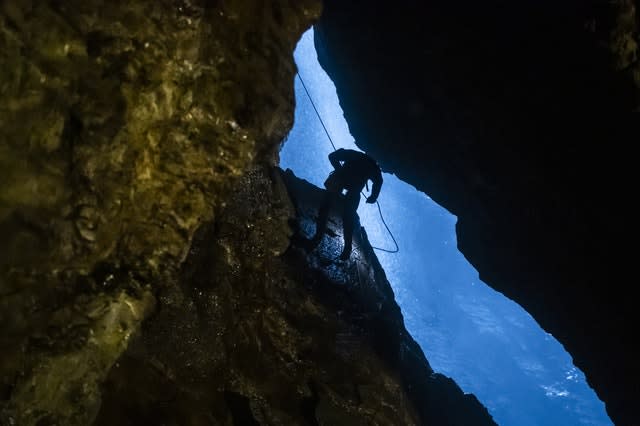 A potholer abseils into Gaping Gill