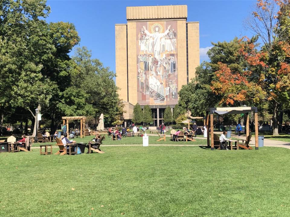 Students sit outside and take a break between classes on the campus of Notre Dame University in South Bend, Indiana on October 6, 2020. (Robert Chiarito/AFP via Getty Images)