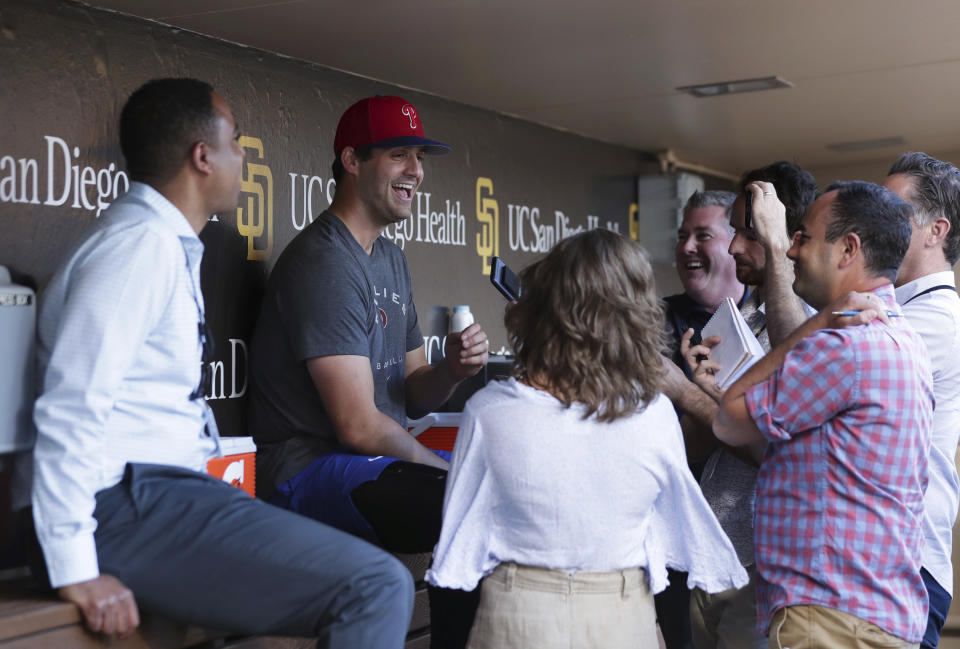 Philadelphia Phillies relief pitcher Mark Appel, second from the left, talks to reporters prior to the team's baseball game against the San Diego Padres, Saturday, June 25, 2022, in San Diego. Appel, the 2013 No. 1 overall pick in the draft, received his first major league call-up Saturday at the age of 30. (AP Photo/Derrick Tuskan)