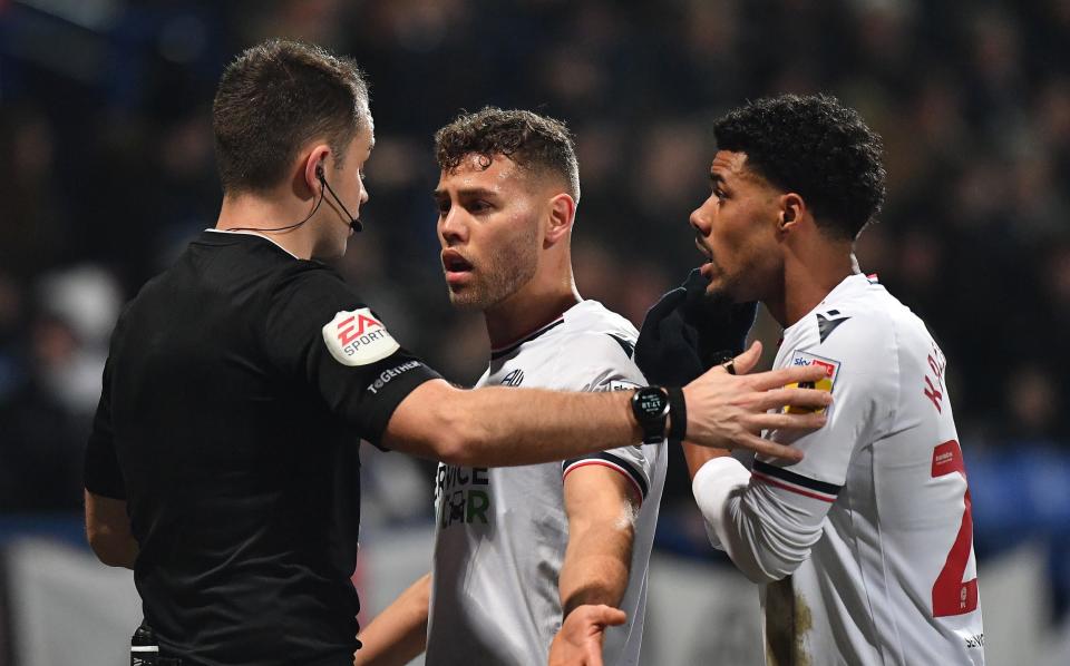 Bolton Wanderers' Dion Charles argues with Referee Tom Nield - Referee appears to send off wrong Bolton player for punching opponent - Getty Images/Dave Howarth