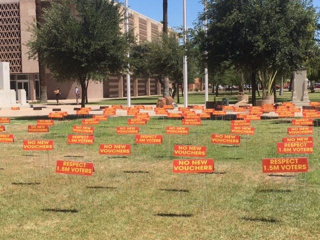 Save Our Schools planted these signs on the Capitol lawn to urge lawmakers to reject universal vouchers. The bills were planted strategically to catch the eye of certain lawmakers.