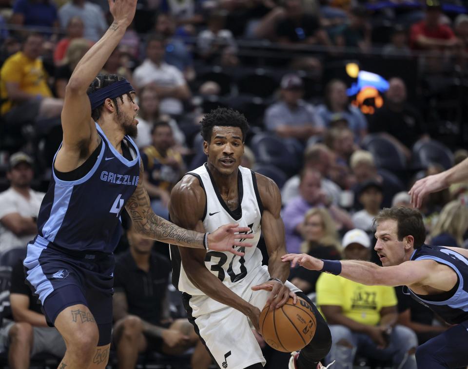 The Memphis Grizzlies’ Timmy Allen, left, and Frankie Ferrari, right, defend the Utah Jazz’s Ochai Agbaji at the Delta Center in Salt Lake City on Thursday, July 6, 2023. | Laura Seitz, Deseret News