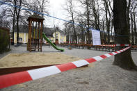 A barrier tape closes off a playground in Munich, Germany, Tuesday, March 17, 2020. German government had announced measure to curb the coronavirus outbreak in the country late Monday. For most people, the new coronavirus causes only mild or moderate symptoms, such as fever and cough. For some, especially older adults and people with existing health problems, it can cause more severe illness, including pneumonia. (AP Photo/Matthias Schrader)