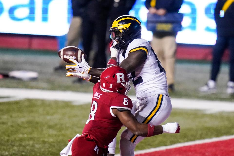 Michigan's Nick Eubanks catches a pass for a touchdown in front of Rutgers' Tyshon Fogg during the second half of an NCAA college football game Saturday, Nov. 21, 2020, in Piscataway, N.J. Michigan won 48-42 in three overtimes.
