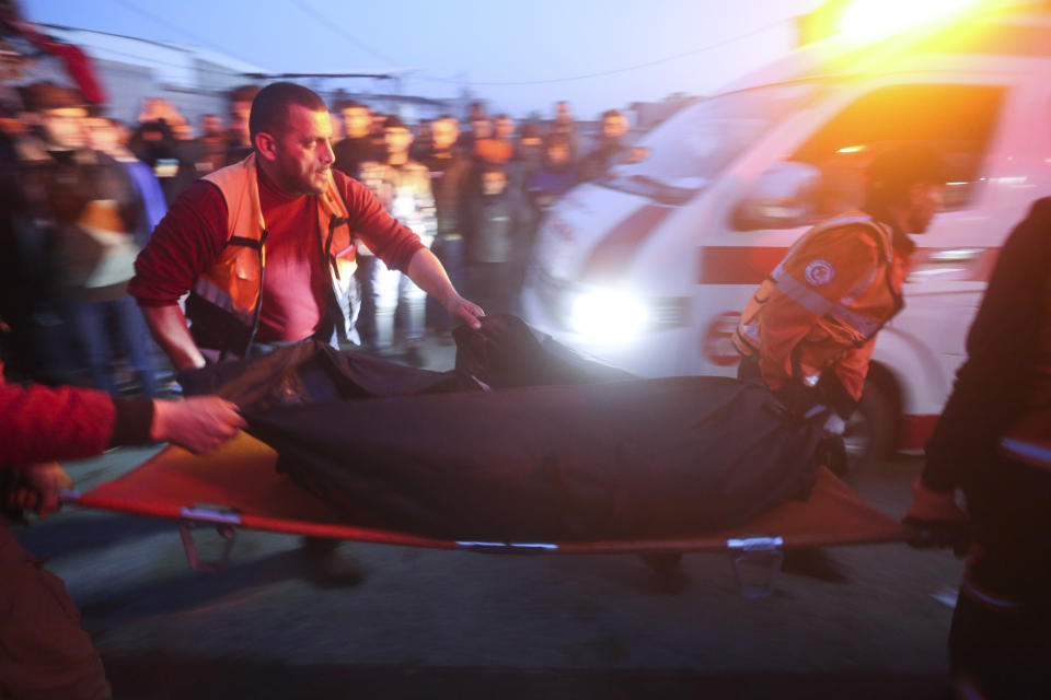 Palestinians remove a body from a car that was hit by an Israeli airstrike in Rafah, Gaza Strip, Saturday, Jan. 20, 2024. (AP Photo/Hatem Ali)