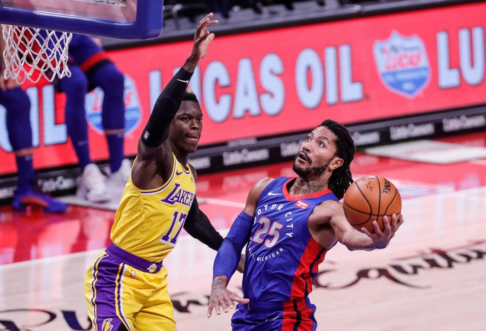 Derrick Rose makes a layup against Lakers guard Dennis Schroder on Jan. 28, 2021 at Little Caesars Arena.