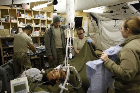 U.S. MAJ. David R. King MD (2nd L), Chief of Surgical Services of 125 BSB Forward Surgical Team Task Force Mustang, in Forward Operating Base (FOB) Shank in Logar province, eastern Afghanistan in this November 13, 2011 file photo. REUTERS/Umit Bektas