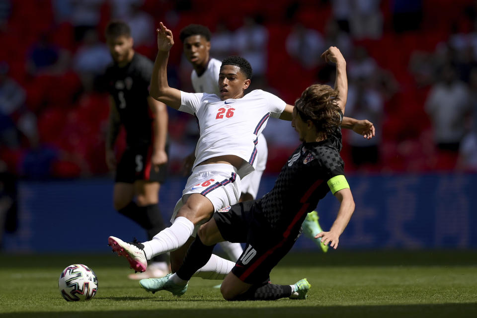 England's Jude Bellingham is challenged by Croatia's Luka Modric, right, during the Euro 2020 soccer championship group D match between England and Croatia, at Wembley stadium, London, Sunday, June 13, 2021. (Laurence Griffiths, Pool via AP)