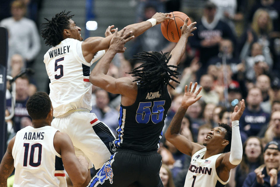 Connecticut's Isaiah Whaley (5) blocks a shot attempt by Memphis' Precious Achiuwa (55) during the second half of an NCAA college basketball game Sunday, Feb. 16, 2020, in Hartford, Conn. (AP Photo/Jessica Hill)